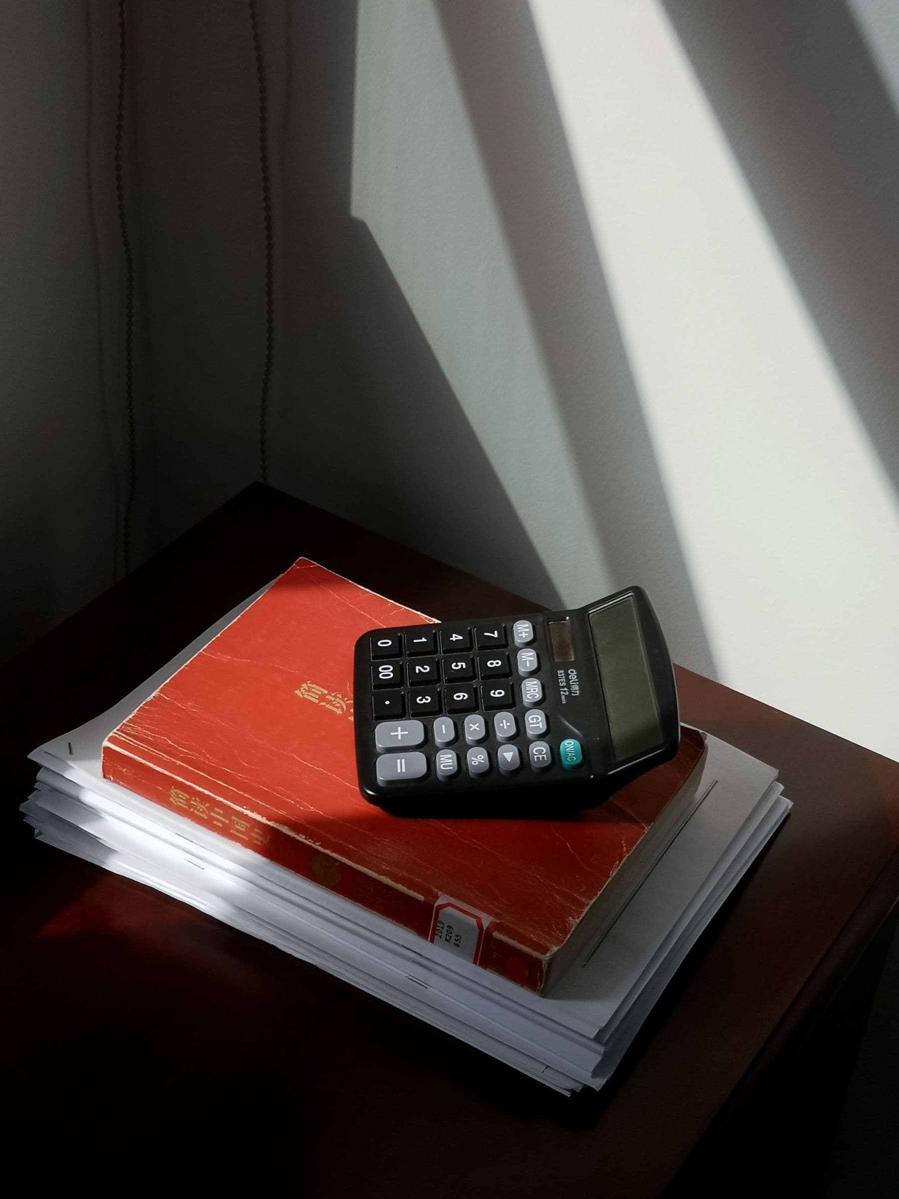 A calculator and accounting ledgers arranged for review