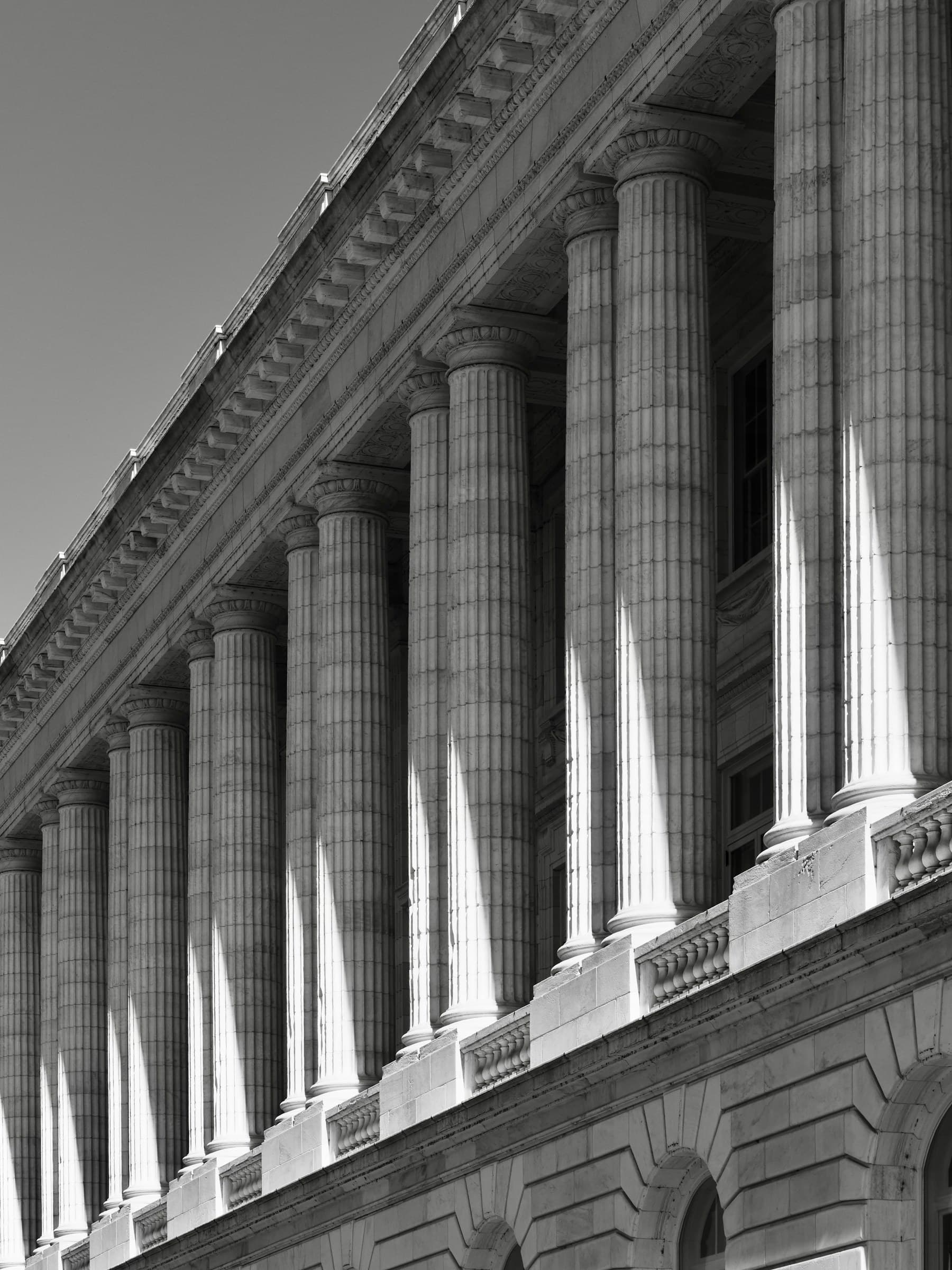 A civic building facade with classical columns and structural shadows
