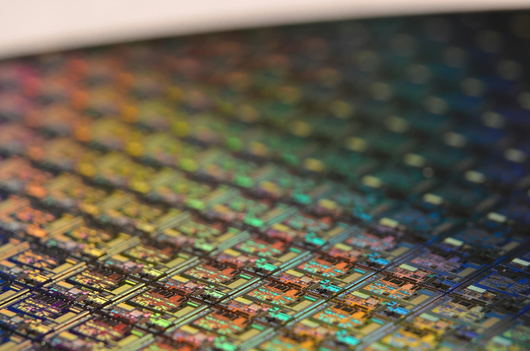 A silicon wafer carrying a green and gold spectrum