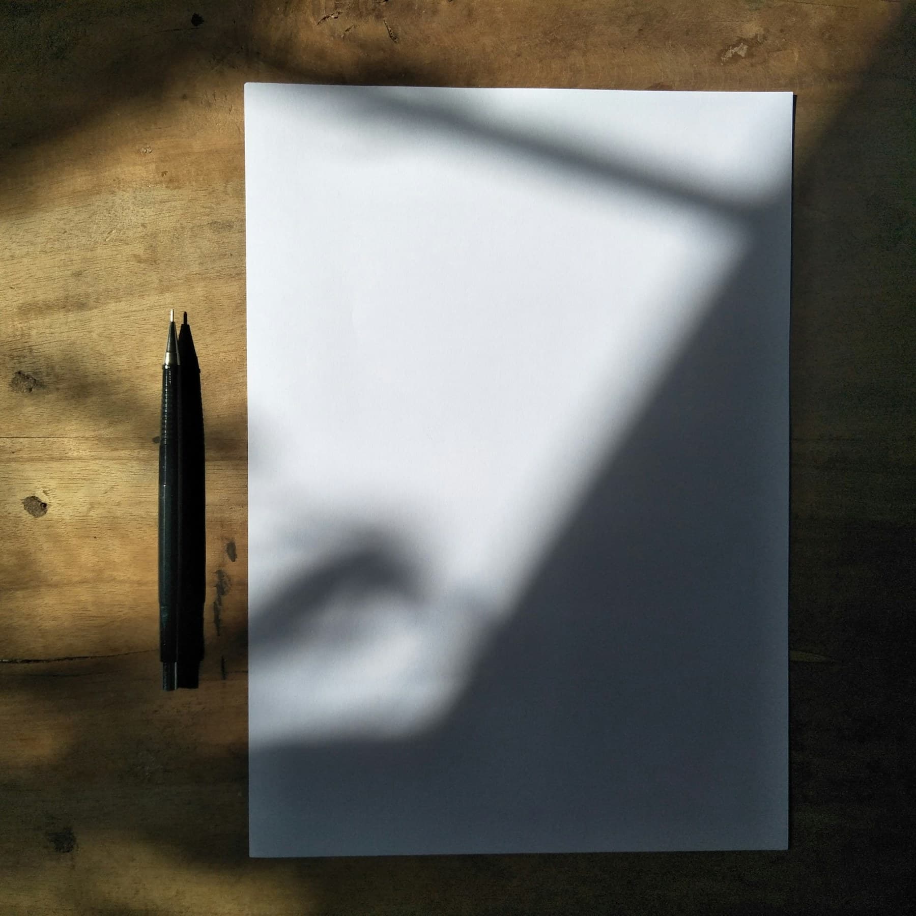 A blank sheet and pen in a structured composition