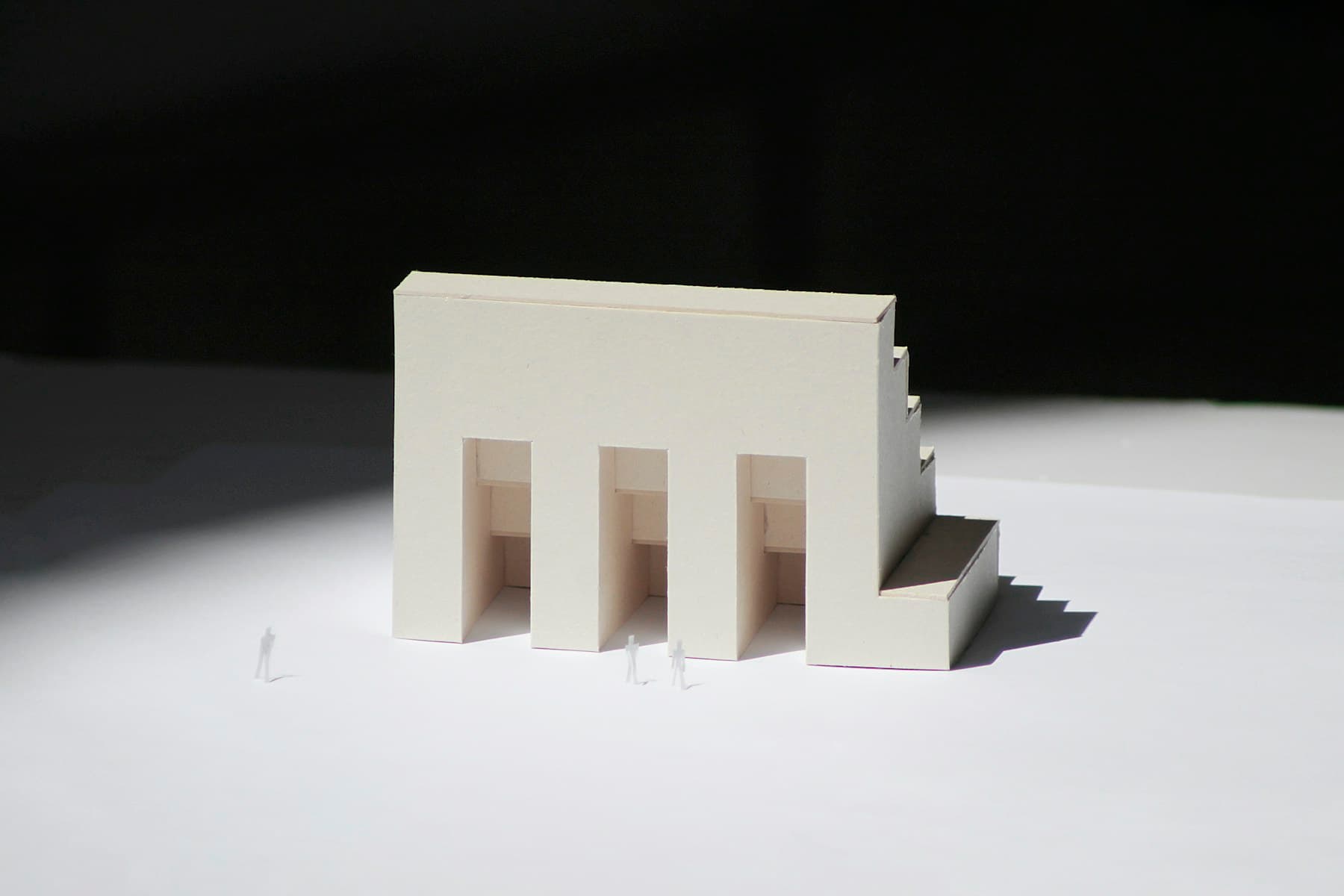 A white architectural model arranged on a precise geometric plane