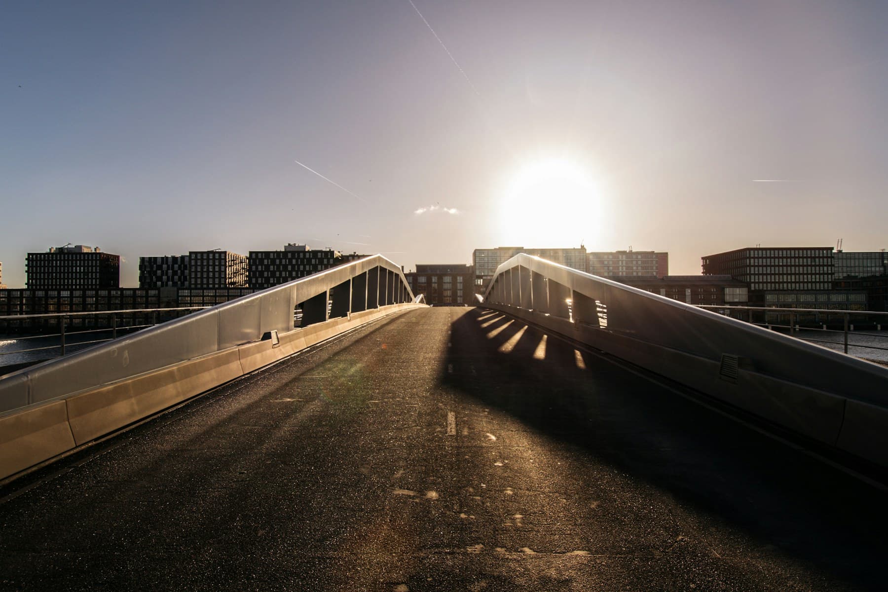 A concrete bridge rising toward the horizon