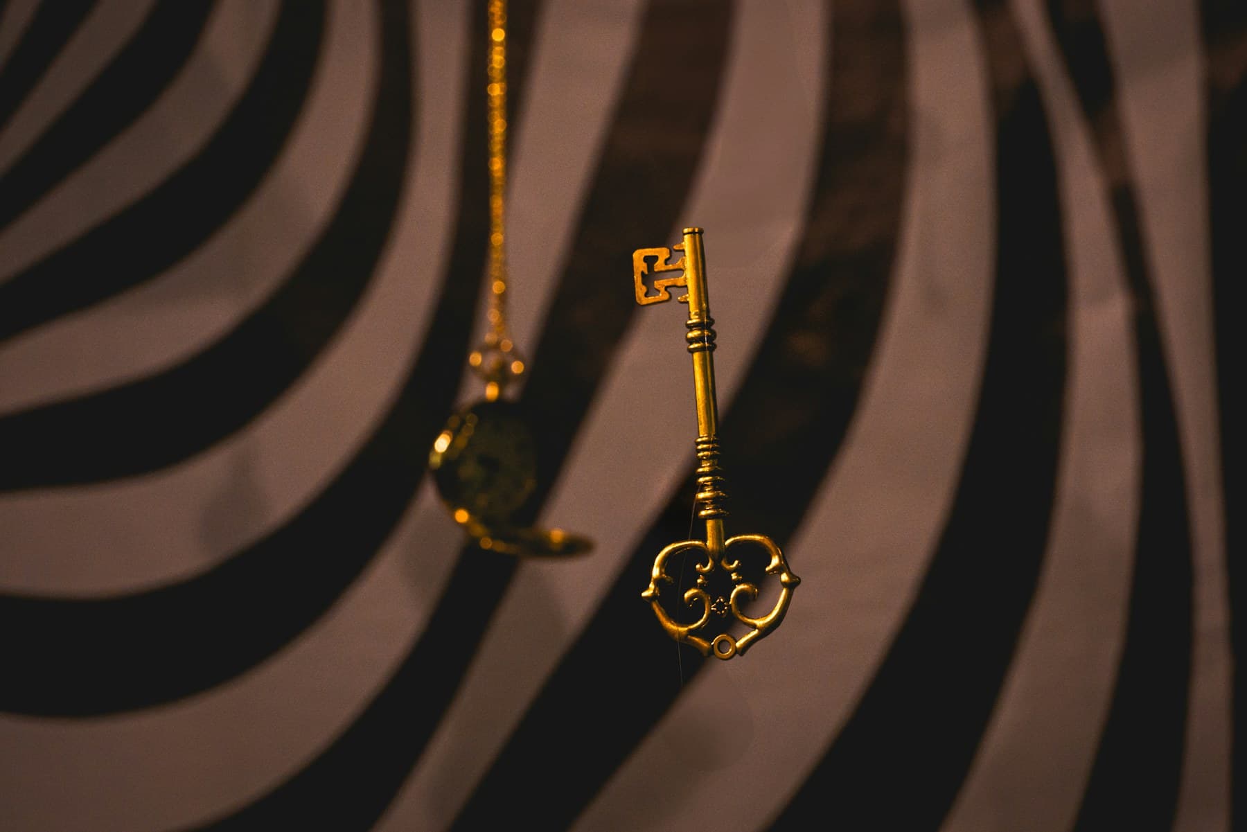 A gold key crossing narrow architectural shadows