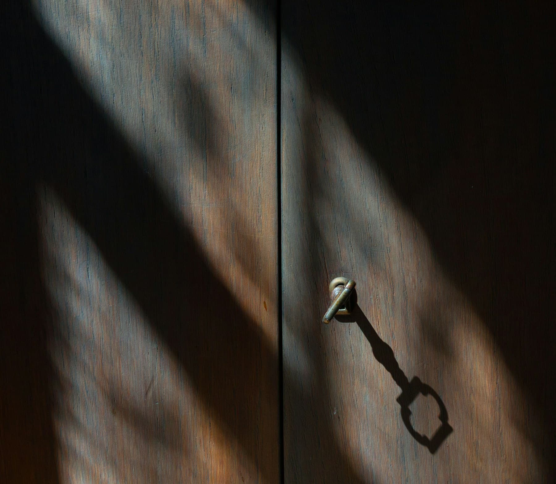A metal door handle at a clear threshold