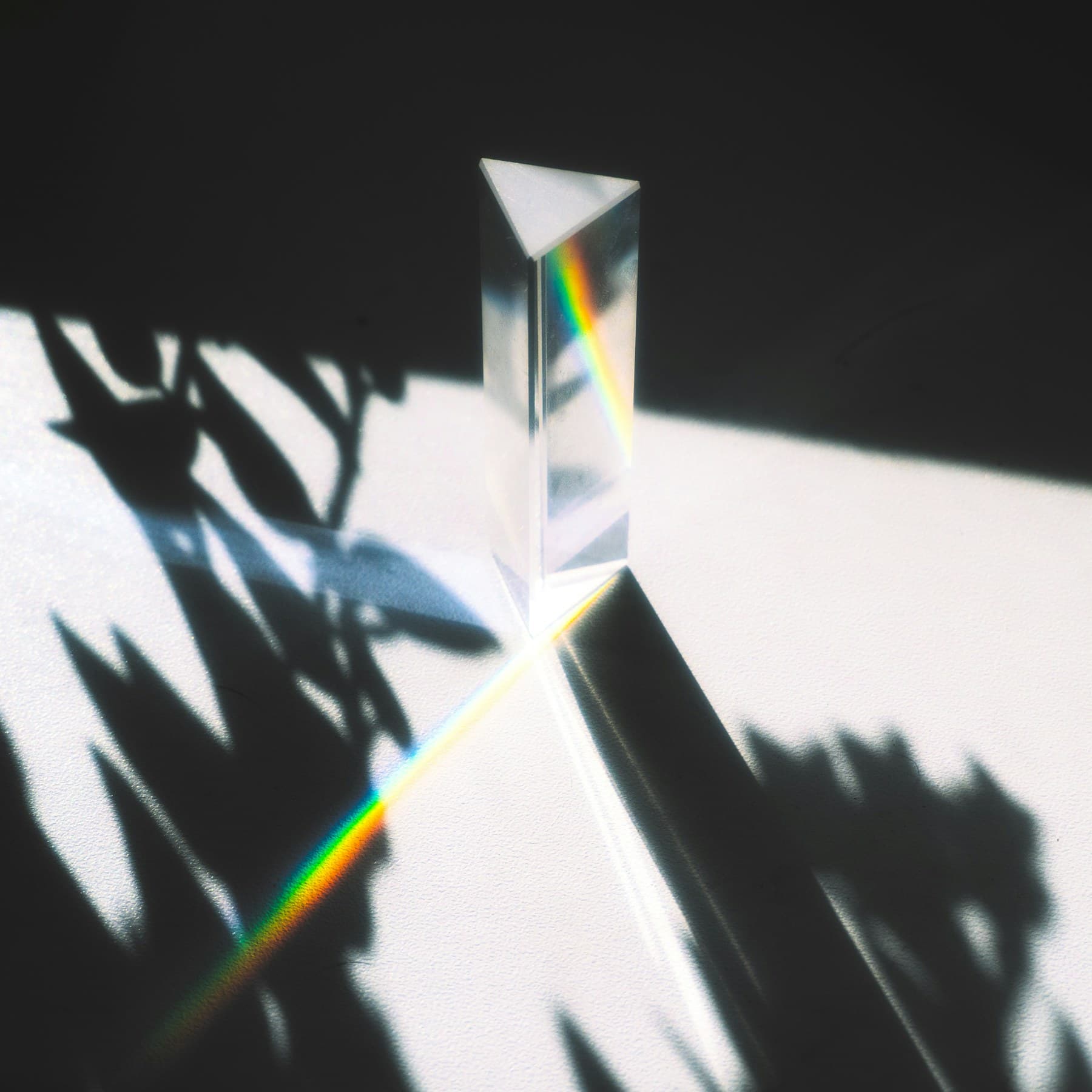 A glass prism separating a visible color spectrum